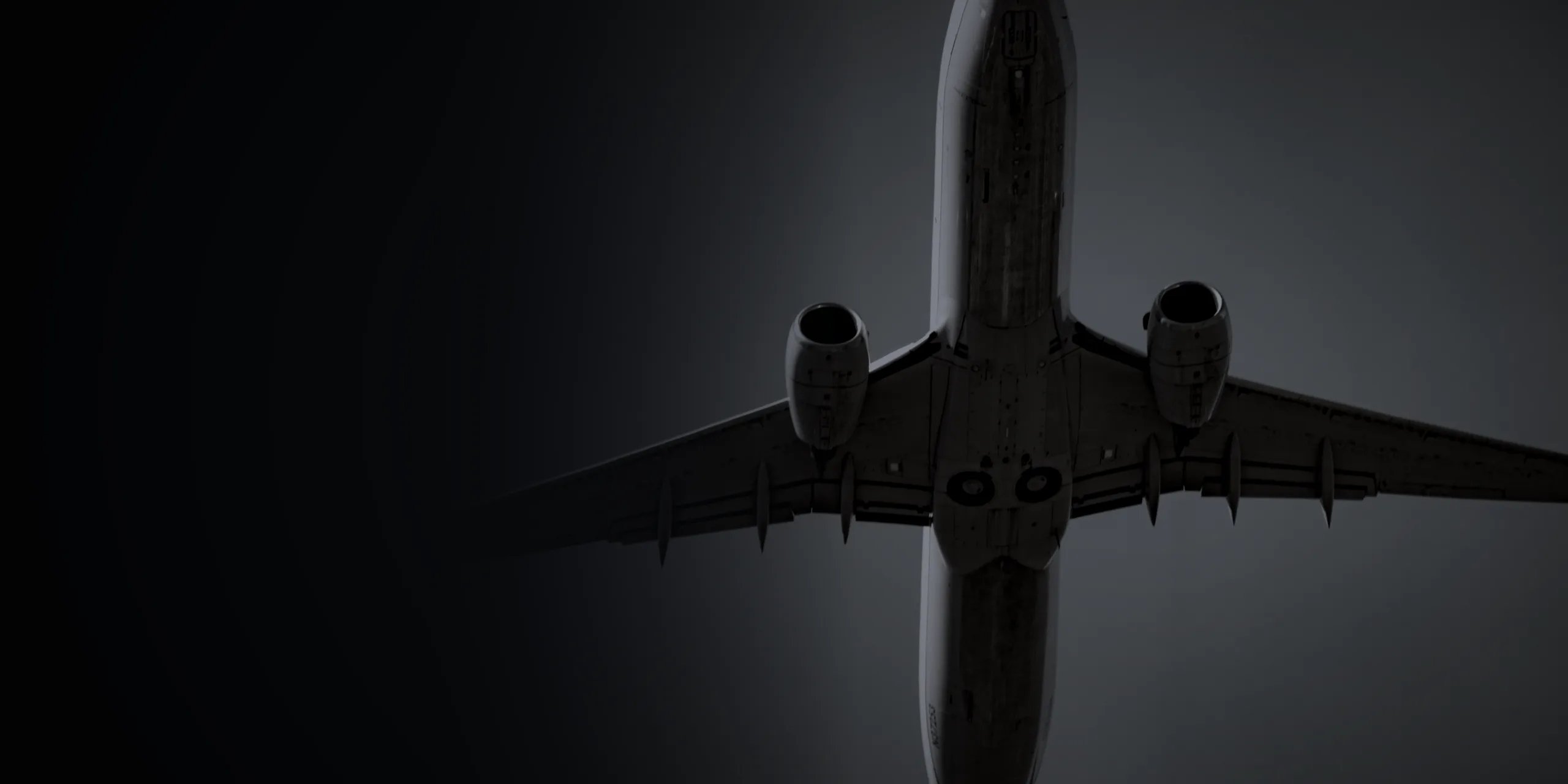 Jet aircraft overhead against a dark sky